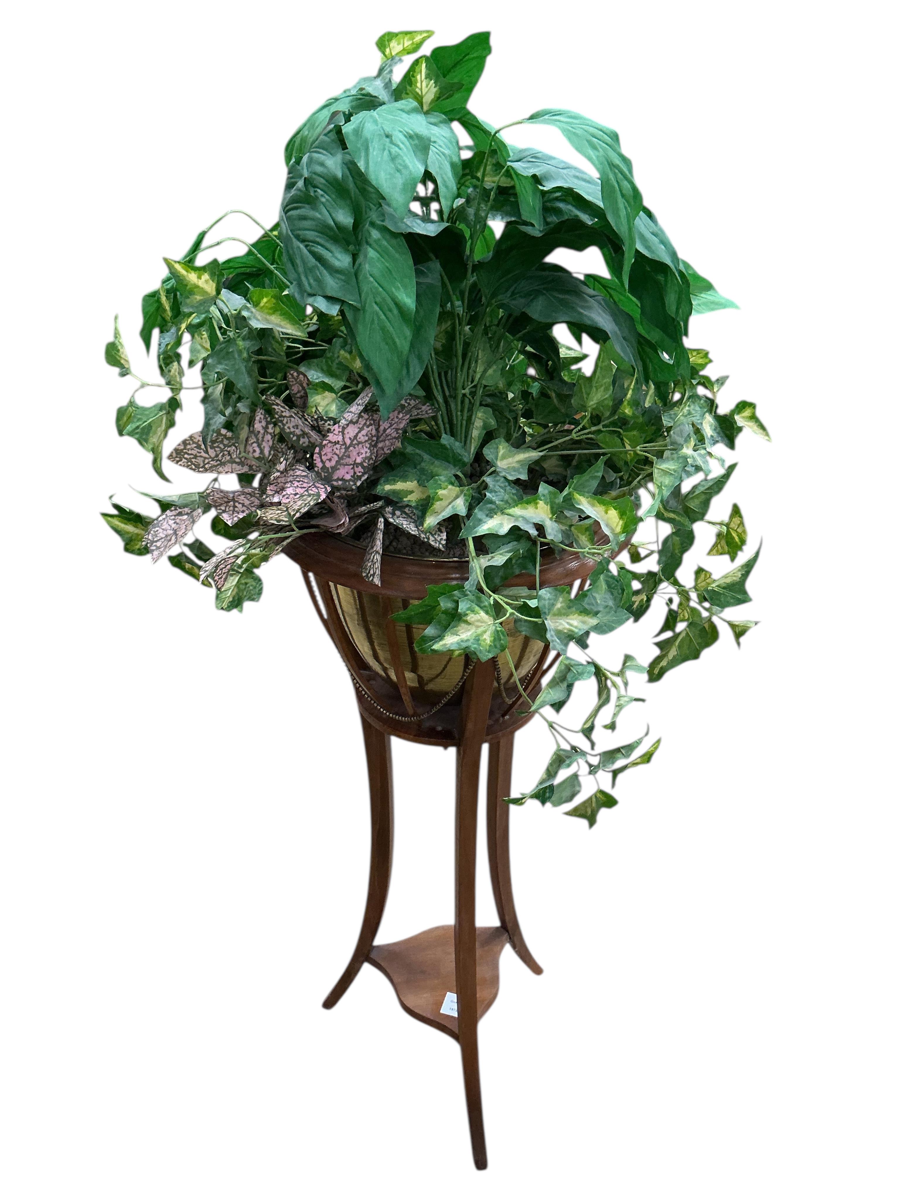 An Edwardian mahogany jardiniere with brass liner, height 85cm